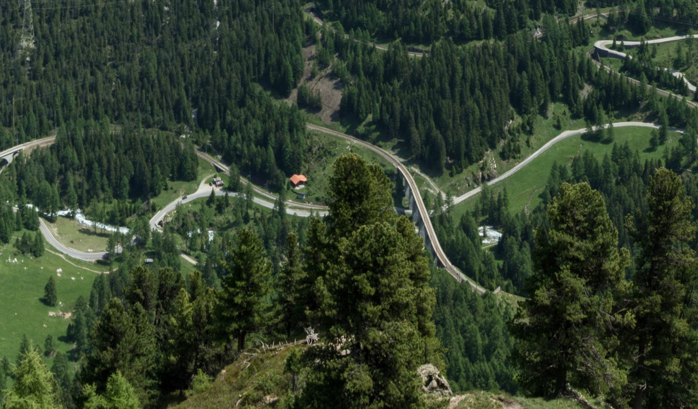 Aerial view of the Albula railway viaducts and winding pass road between Berg&uuml;n and Preda, Switzerland
