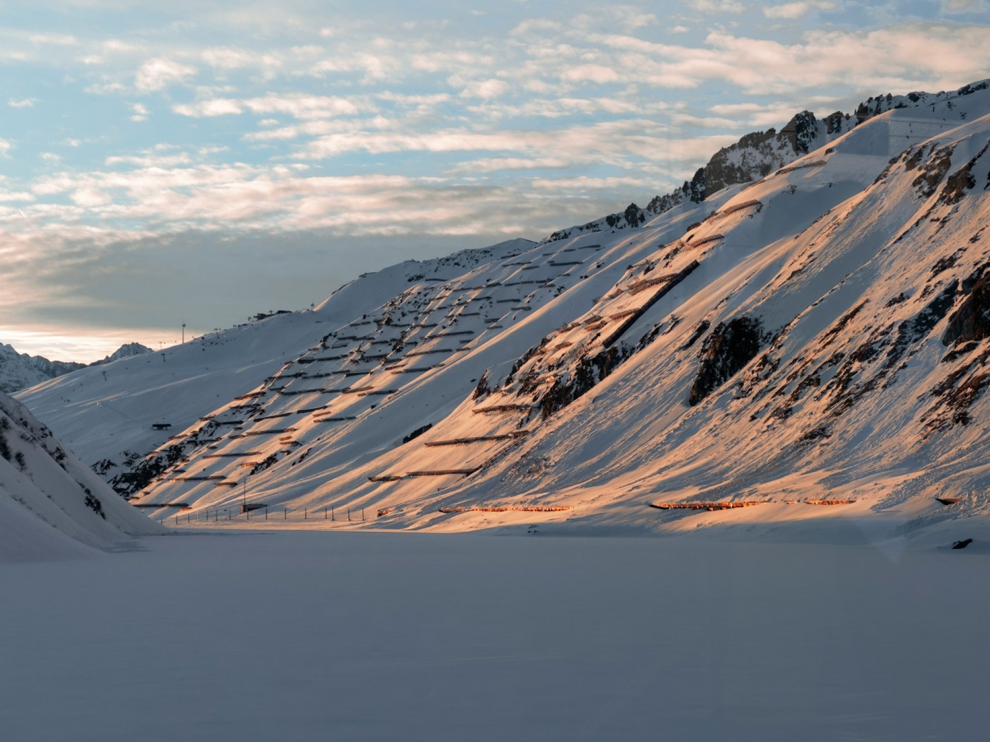 Vehicles on Oberalp Pass road between green mountains beneath a blue sky. Authentic Oberalppass, Tujetsch image by Bart Luppes, verified from its Unsplash photo page. Free Unsplash License.